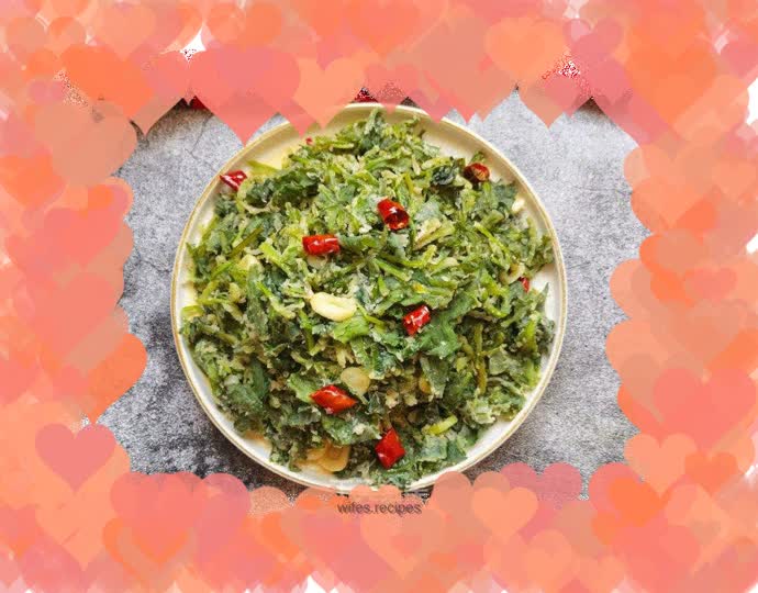 Stir-fried dandelion with garlic cloves and chili pepper