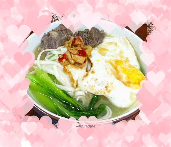 Beef noodle soup with baby green vegetables and poached egg